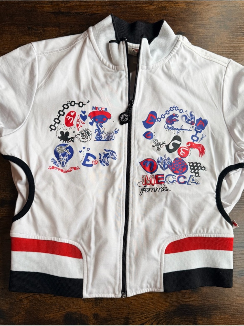 Mecca Femme zip-up top.  Red, white, blue and black.  Great graphics!